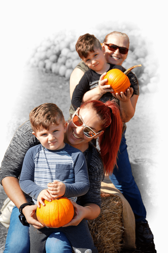 Family holding pumpkins
